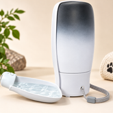 Grey folding dog water dispenser with wrist strap