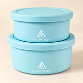 Two blue dog food bowls stacked with lids
