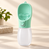 Green and white dog water dispenser with drinking trough