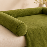 Close-up of a green dog sofa mat with raised bolster